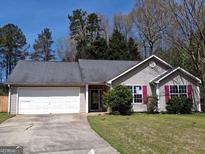 Charming single-story home with a two-car garage and manicured lawn at 172 Willow Springs Ln, Stockbridge, GA 30281