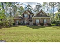 Charming brick home with a manicured lawn and mature trees at 4360 Derrick Rd, South Fulton, GA 30349