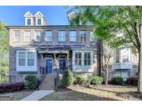 Charming brick townhome with well-manicured landscaping and inviting entryway at 7920 Willoughby Ct, Alpharetta, GA 30005