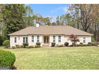 Stunning single-story home with a well-manicured lawn and mature landscaping at 110 Kylemore Pass, Tyrone, GA 30290