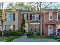 Charming brick townhome featuring a well-maintained front yard and classic architectural details at 11419 South Grove Dr, Hampton, GA 30228