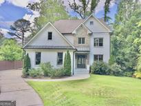 Charming two-story home with a stone and painted brick exterior and well-manicured front lawn at 906 Winall Down Ne Rd, Atlanta, GA 30319