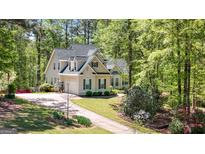 Charming two-story home with a well-manicured lawn, dark shutters, and a long, private driveway at 210 Sweetwater Dr, Fayetteville, GA 30214