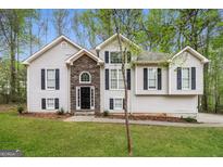 Charming two-story home featuring a stone entryway and well-maintained landscaping for curb appeal at 149 Camden Woods Pl, Dallas, GA 30157