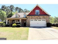 Charming two-story home with stone accents, a well-manicured lawn, and an attached two-car garage at 108 Stonecrest Dr, Carrollton, GA 30116