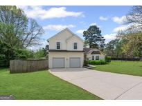 Charming two-story home with a two-car garage and well-manicured lawn at 2550 Columbia Crossing Ct, Decatur, GA 30034