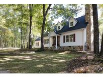 Charming two-story home featuring dormer windows, stone accents, and a well-manicured lawn at 230 Haynes Rd, Moreland, GA 30259