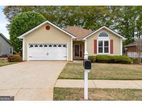 Charming single-story home featuring a two-car garage, well-kept lawn, and inviting curb appeal at 210 Brittany Chase, Fayetteville, GA 30214