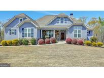 Charming home with a stone and siding facade, landscaped front yard, and covered front porch at 270 Blue Point Pkwy, Fayetteville, GA 30215