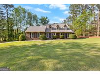 Charming brick home with well-manicured lawn and mature landscaping in a peaceful, established neighborhood at 105 Hartford Pl, Fayetteville, GA 30214