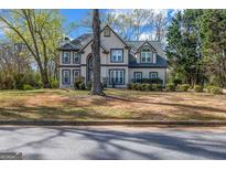 Charming two-story home with neutral siding, trimmed windows, mature landscaping, and a classic architectural style at 3139 Players Dr, Jonesboro, GA 30236