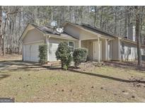 Charming single-story home with a well-maintained yard and attached garage at 1109 Allen Rd, Grantville, GA 30220