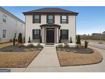 Charming two-story brick home featuring a landscaped yard, covered entrance, and black window shutters at 1461 Thomas St, Conyers, GA 30094