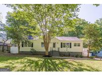 Charming single-Gathering home with a well-manicured lawn, mature trees, and inviting curb appeal at 1050 N Carter Rd, Decatur, GA 30030