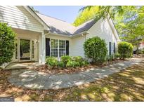 Charming home featuring traditional architecture, manicured landscaping, and inviting entryway at 12843 Simmons Rd, Hampton, GA 30228