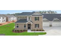 A welcoming two-story home with a brick facade and lush green lawn at 576 Silver Moon Dr, Loganville, GA 30052