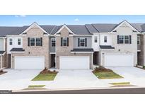 Charming new townhomes with attached garages, varied facades, and inviting curb appeal in a modern community at 335 Silver Moon Dr, Loganville, GA 30052