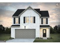 Charming two-story home with white brick, black shutters, and a two-car garage at 5389 Tolar Road # 36, South Fulton, GA 30213