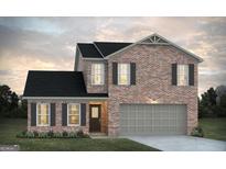 Charming two-story brick home featuring a two-car garage, black shutters, and a well-maintained lawn at 5360 Tolar Rd # 72, South Fulton, GA 30213