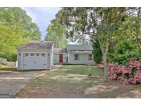 Charming single-Gathering home with a spacious front yard, attached garage, and colorful landscaping at 113 Kings Ridge Dr, Peachtree City, GA 30269