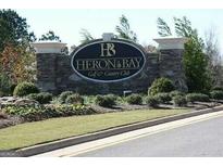 Stone entrance sign for Heron Bay Golf & Country Club at 1213 Dawnview Dr, Locust Grove, GA 30248