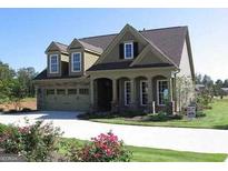 Charming home with a two-car garage, dormer windows, and beautifully landscaped front yard at 1213 Dawnview Dr, Locust Grove, GA 30248