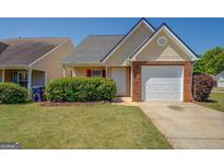Charming single Gathering home with a one car garage and a well maintained lawn at 20 Highgate Trl, Covington, GA 30016