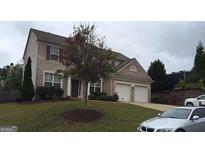 Charming two-story home featuring a brick facade, well-maintained lawn, and an attached two-car garage at 450 Hillingdon Way, Suwanee, GA 30024