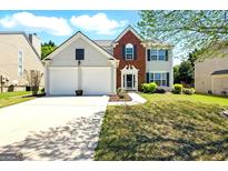Charming two-story home featuring a two-car garage, brick accents, and well-maintained landscaping at 340 Hammersmith Dr, Suwanee, GA 30024