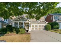 Inviting two-story home featuring a two-car garage and a well-maintained front yard with lush landscaping at 1535 Justine Se Way, Mableton, GA 30126