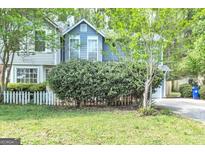 Charming two-story home featuring a well-maintained lawn and a quaint white picket fence at 2998 Kenville Ln, Decatur, GA 30034