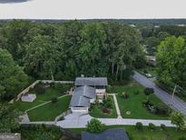 Expansive aerial view of landscaped property featuring a well-maintained yard and mature trees at 4213 Janice Drive, Atlanta, GA 30337