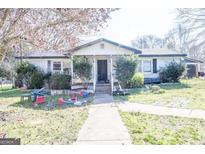Charming single-story home with front yard and sidewalk leading to entryway at 30 Millwood Dr, Covington, GA 30016