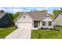 Charming single-Gathering home features a well-manicured lawn, two-car garage, and inviting front entrance at 5910 Stellata Cir, Cumming, GA 30028