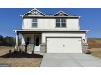 Charming two-story home with a two-car garage, white siding, and a well-manicured front lawn in a quiet neighborhood at 383 Cantrell Drive, Dallas, GA 30157