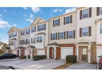Charming townhomes featuring a brick and siding facade, individual garages, and well-maintained landscaping at 6806 Blackstone Pl # 12, Mableton, GA 30126