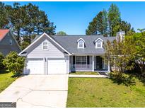 Charming one-story home featuring a two-car garage and well-maintained front yard at 6844 Saganaw Dr, Rex, GA 30273