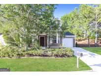 Charming home featuring a brick facade, manicured lawn, and attached garage at 7161 Bowie Dr, Lithonia, GA 30038