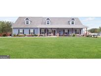 Charming, blue single-story home with a spacious front yard and welcoming front porch at 155 Lawrence Dr, Villa Rica, GA 30180