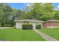 Charming single-story home featuring a manicured lawn and inviting front entrance at 2155 Meador Se Ave, Atlanta, GA 30315