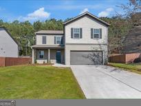 Charming two-story home featuring a gray exterior, well-maintained lawn, and a welcoming front porch at 820 Lake Chase, Fairburn, GA 30213