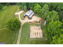 Expansive aerial view of farm, barn and garden on a tree-filled lot at 238 Indian Creek Rd, Locust Grove, GA 30248