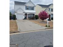 Charming two-story home with a well-maintained front yard and inviting curb appeal at 1711 Taynton Nw Cir, Kennesaw, GA 30152