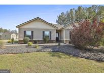 Charming single-story home with well-maintained lawn, landscaping, and neutral siding and trim at 130 S Meadows Ridge Dr, Grantville, GA 30220