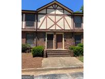 Charming two-story townhome with brick facade, front steps, and well-maintained landscaping at 3244 Abbeywood Dr, Decatur, GA 30034