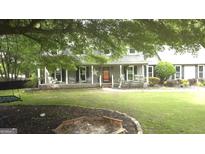 Charming two-story home featuring a covered front porch with a star and swing at 3650 Bay Leaf Dr, Loganville, GA 30052