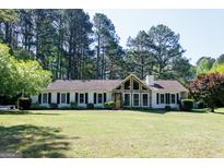 Charming single-story home with a manicured lawn, stone accents and large front windows at 150 Whitney Way, Fayetteville, GA 30214