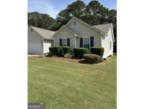 Charming single-story home featuring a well-maintained lawn and classic curb appeal at 12214 Cypress Way, Fayetteville, GA 30215