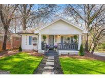 Charming bungalow with blue-trimmed windows, stone pathway, and well-manicured lawn at 1766 Ware Ave, East Point, GA 30344