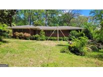 A single-story brick home with an expansive front yard at 1198 Lynhurst Sw Dr, Atlanta, GA 30311